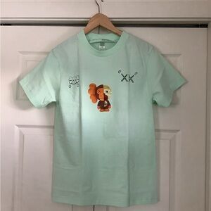 KAWS X Mainlabel.. Graphic Mint Green  T-Shirt.. UNISEX , BRAND NEW